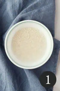 overhead image of rice soaking in bowl with number one in bottom right corner
