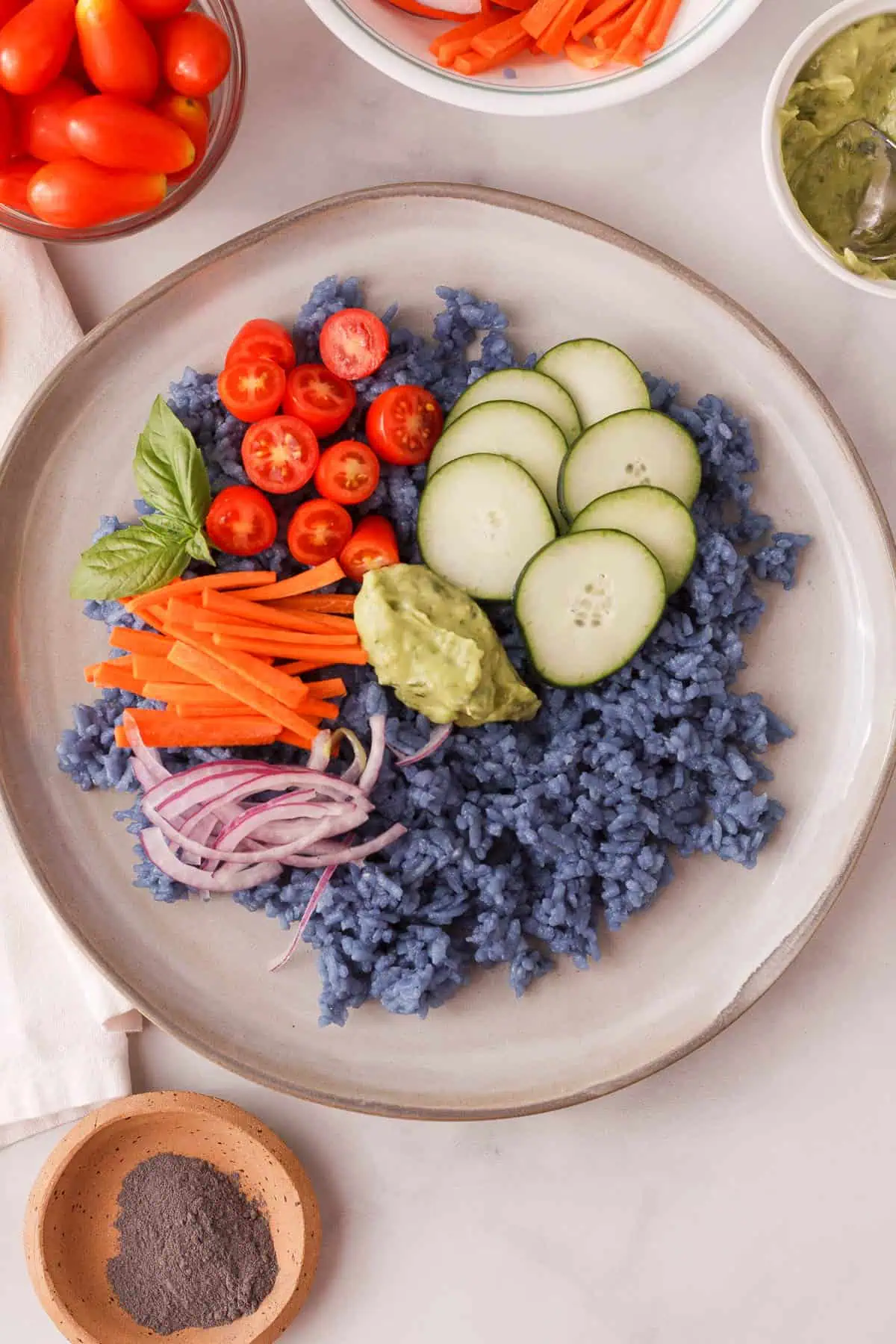 overhead image of butterfly pea rice bowl with added veggies