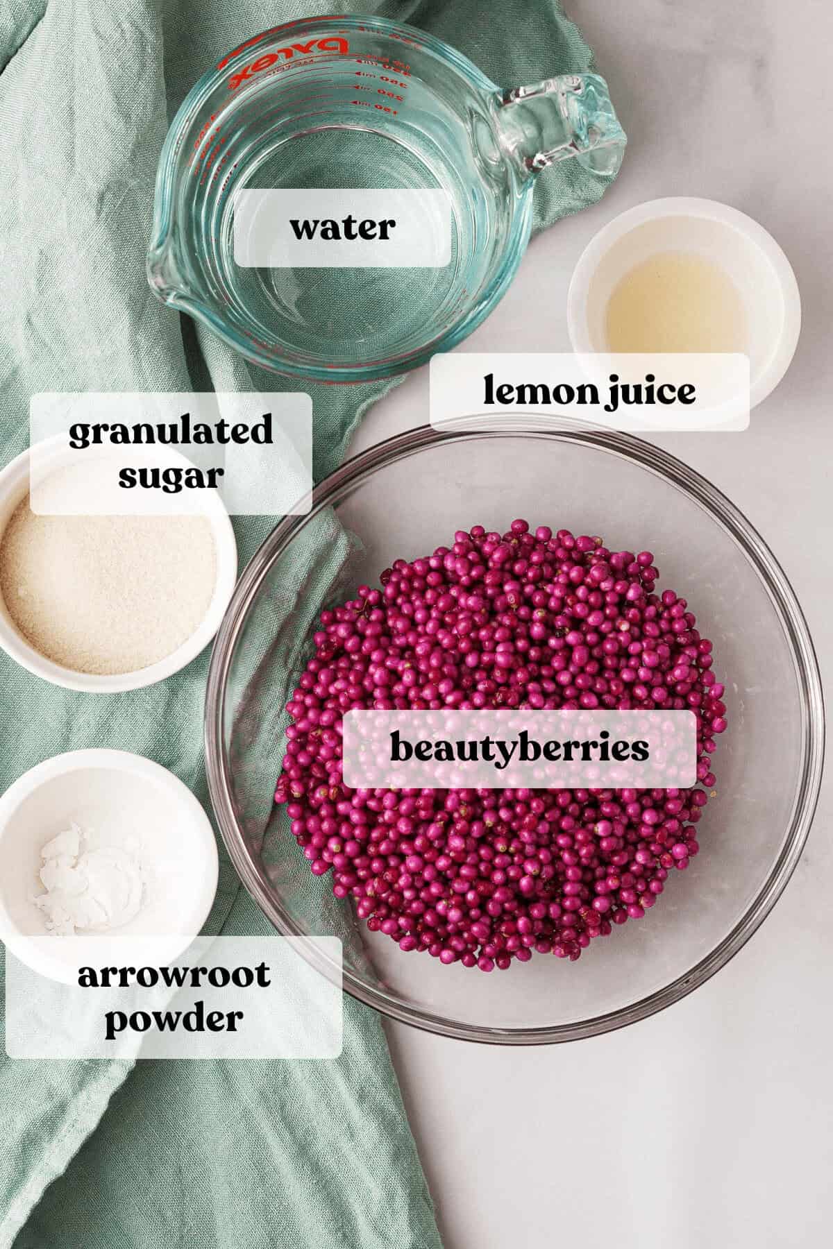overhead image of beautyberry jelly ingredients on table with labels