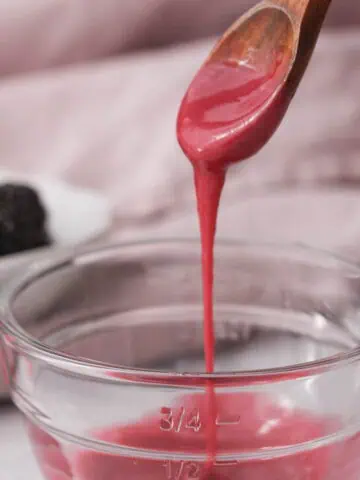 blackberry icing glaze dripping from spoon