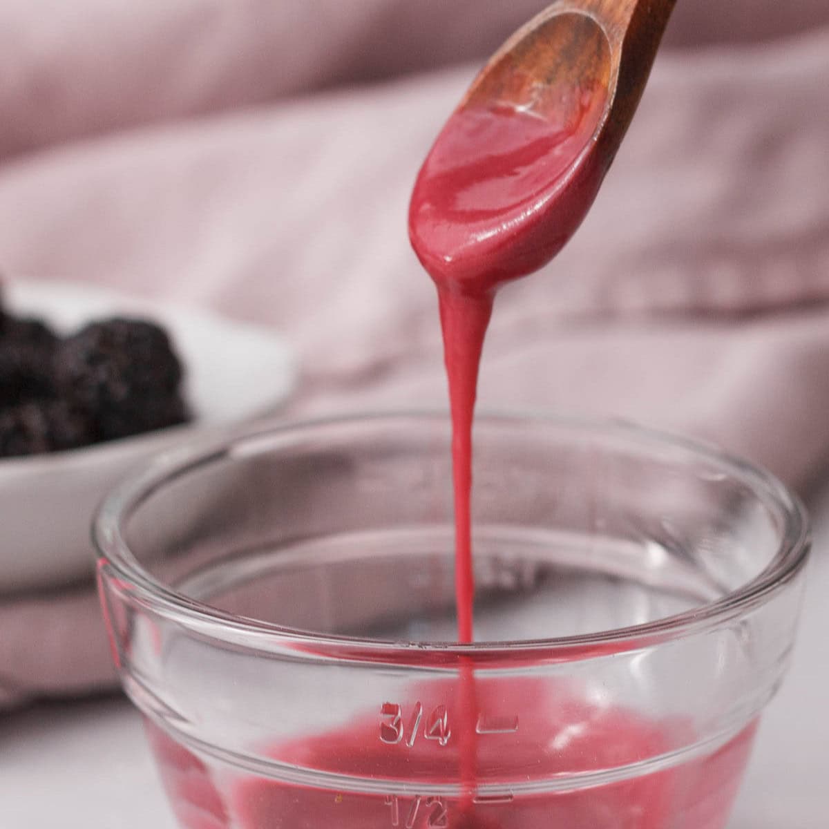blackberry icing glaze dripping from spoon