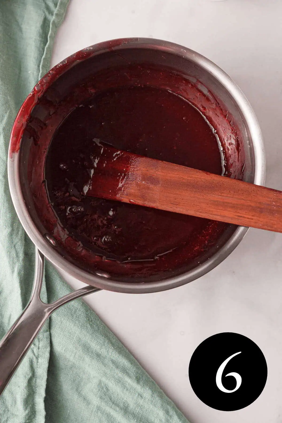 overhead image of concentrated beautyberry jelly in pot with number six in the bottom right corner