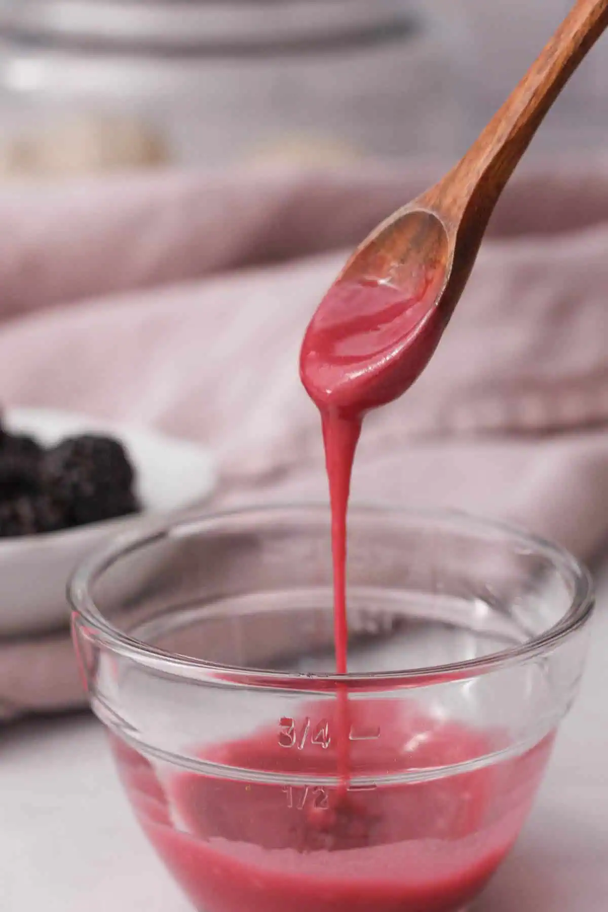 blackberry icing glaze dripping from spoon