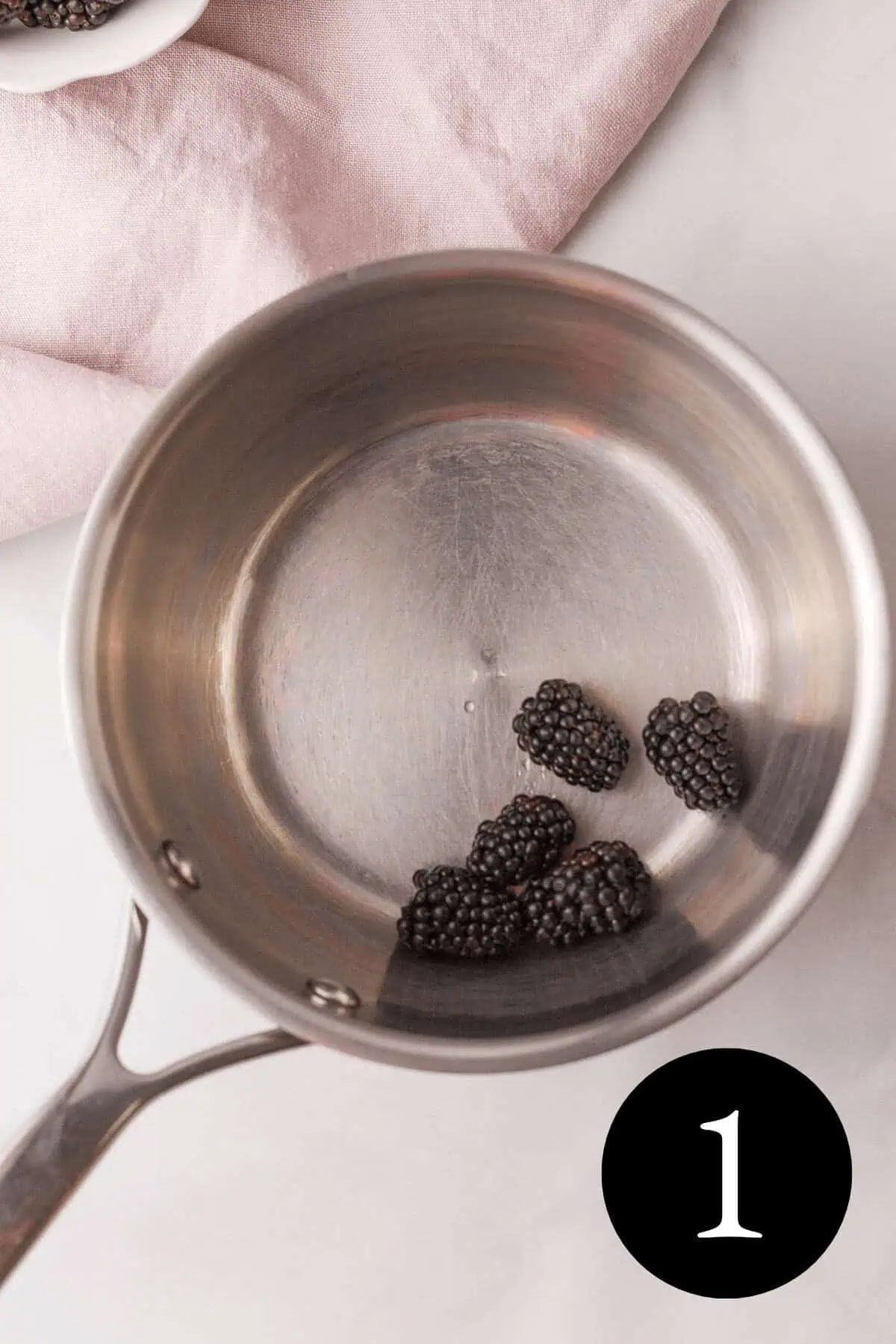 overhead image of blackberries in saucepan with number one in bottom right corner