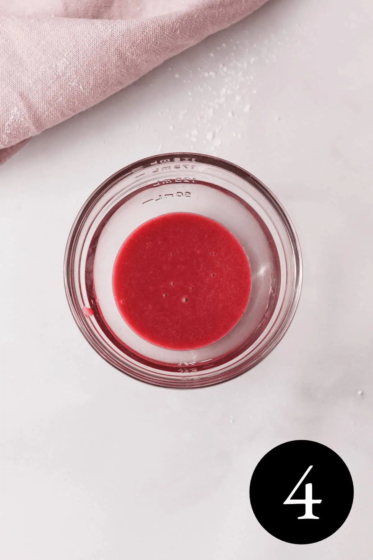 overhead image of blackberry icing in a glass bowl with number four in the bottom right corner