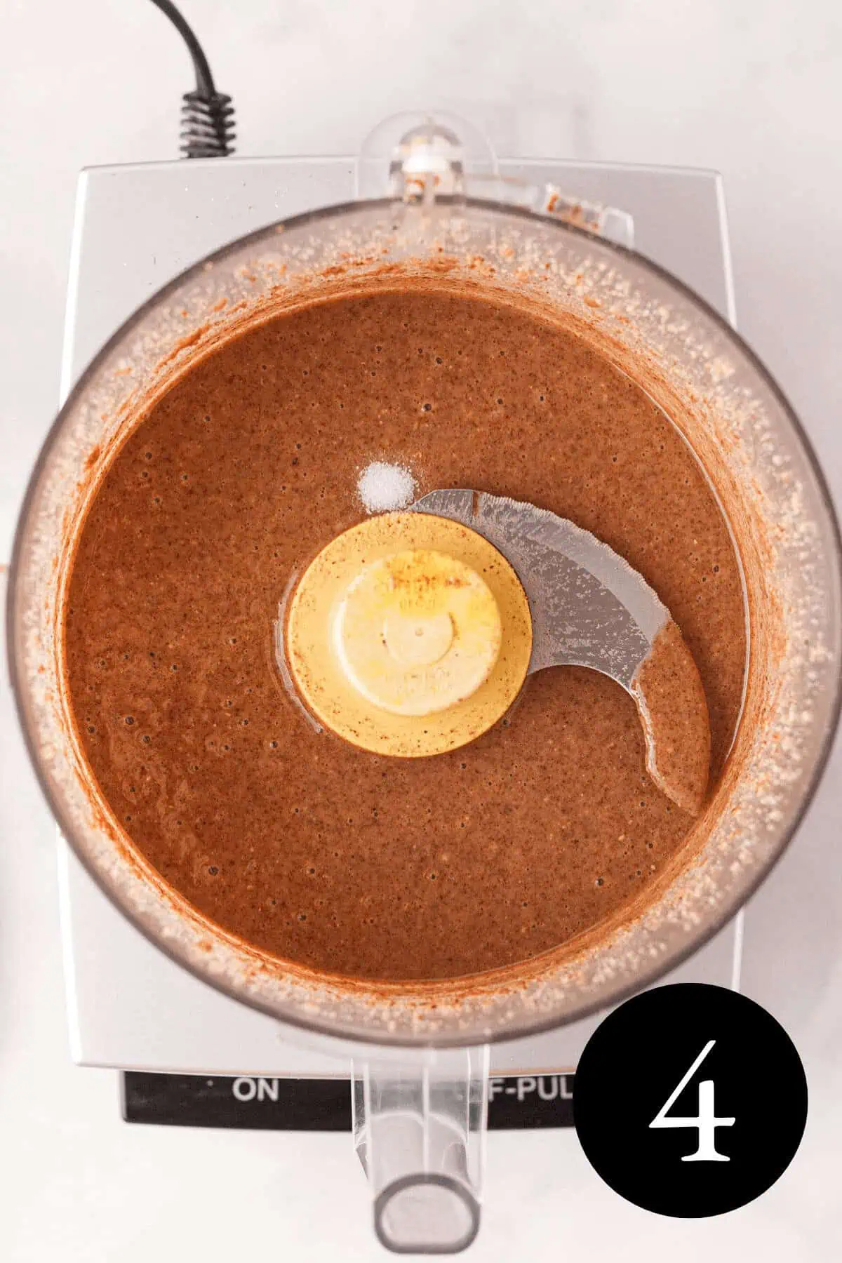 overhead image of pecan butter with pinch of salt resting on top and number four in the bottom right corner