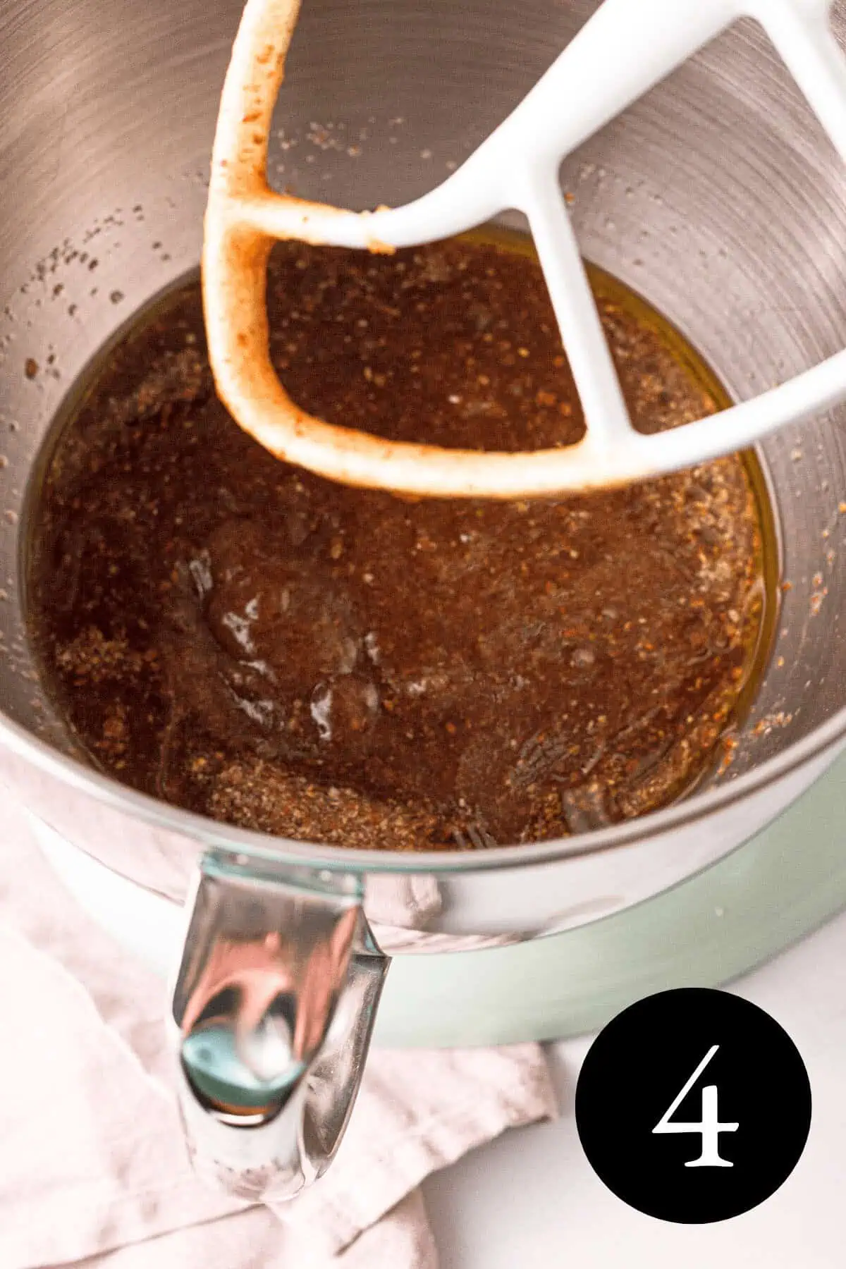 overhead image of wet ingredients mixed together in bowl with number four in bottom right corner
