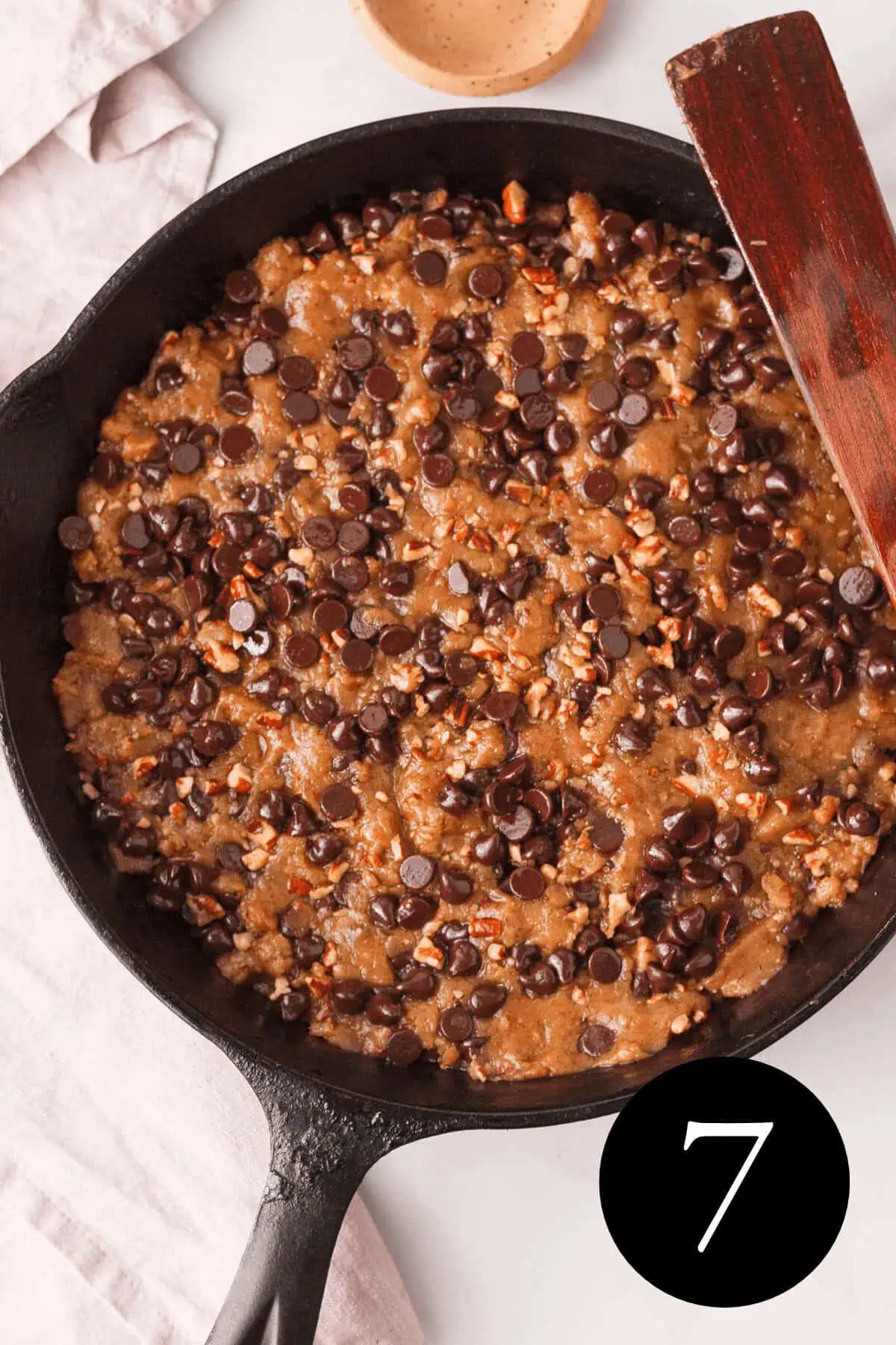 overhead image of cookie dough in skillet with number seven in bottom right corner
