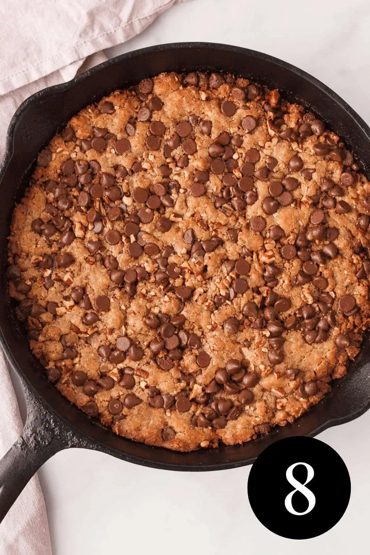 overhead image of baked pizookie with number eight in the bottom right corner