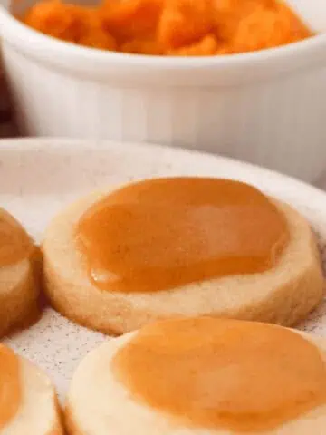 square cropped image of pumpkin icing glaze on cookies
