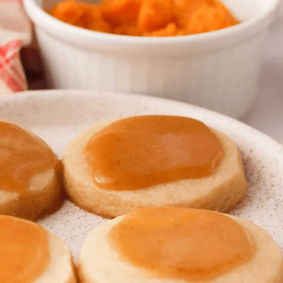 square cropped image of pumpkin icing glaze on cookies