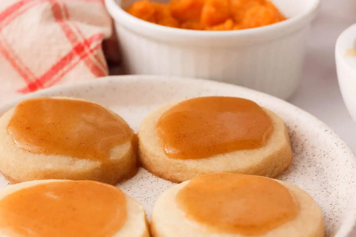 closeup of pumpkin icing glaze on shortbread cookies