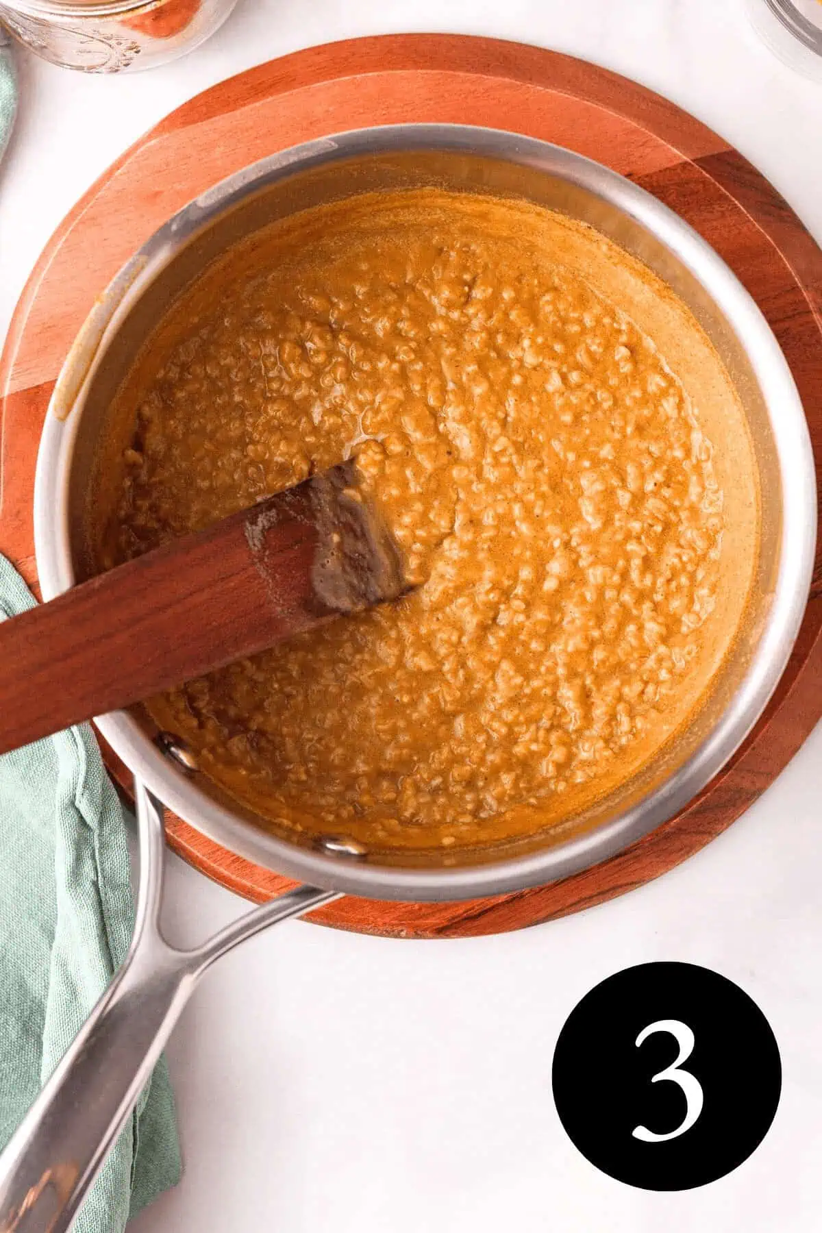 overhead image of creamy pumpkin steel cut oats in saucepan with number three in bottom right corner