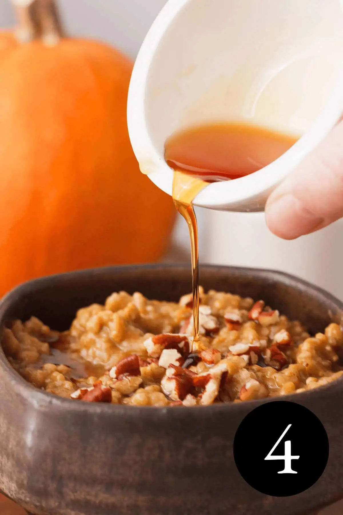 angled image of maple syrup pouring over bowl of pumpkin oatmeal with number four in bottom right corner